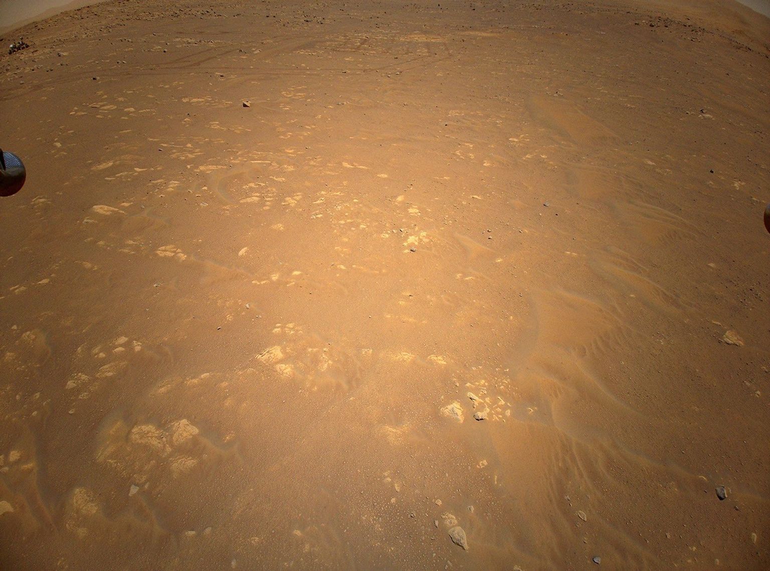 NASA's Perseverance Mars rover is visible in the upper left corner of this image the agency's Ingenuity Mars Helicopter took during its third flight, on April 25, 2021.