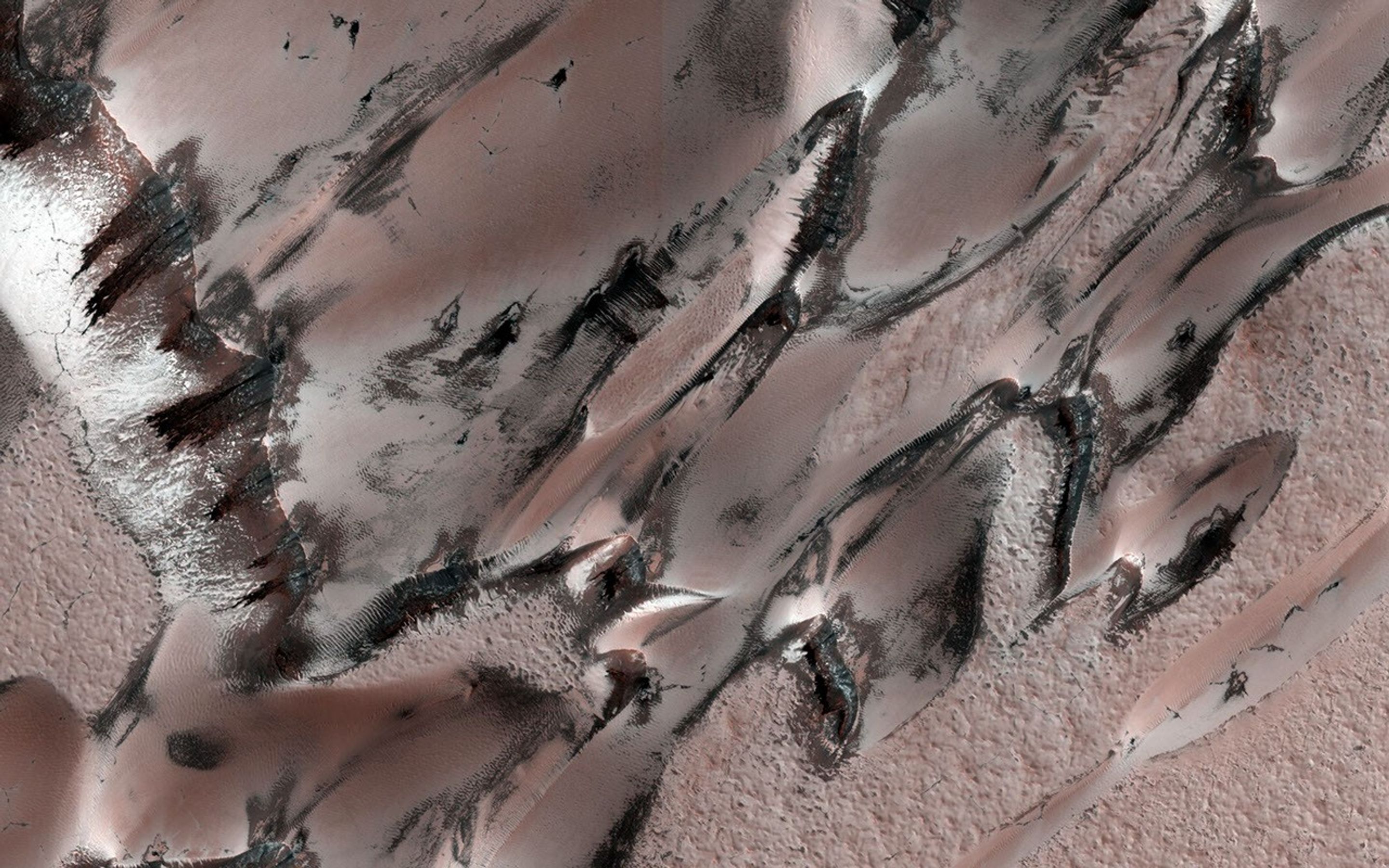 This image acquired on May 6, 2021 by NASA's Mars Reconnaissance Orbiter, shows a unique polar dune field during northern spring, revealing some interesting patterns.