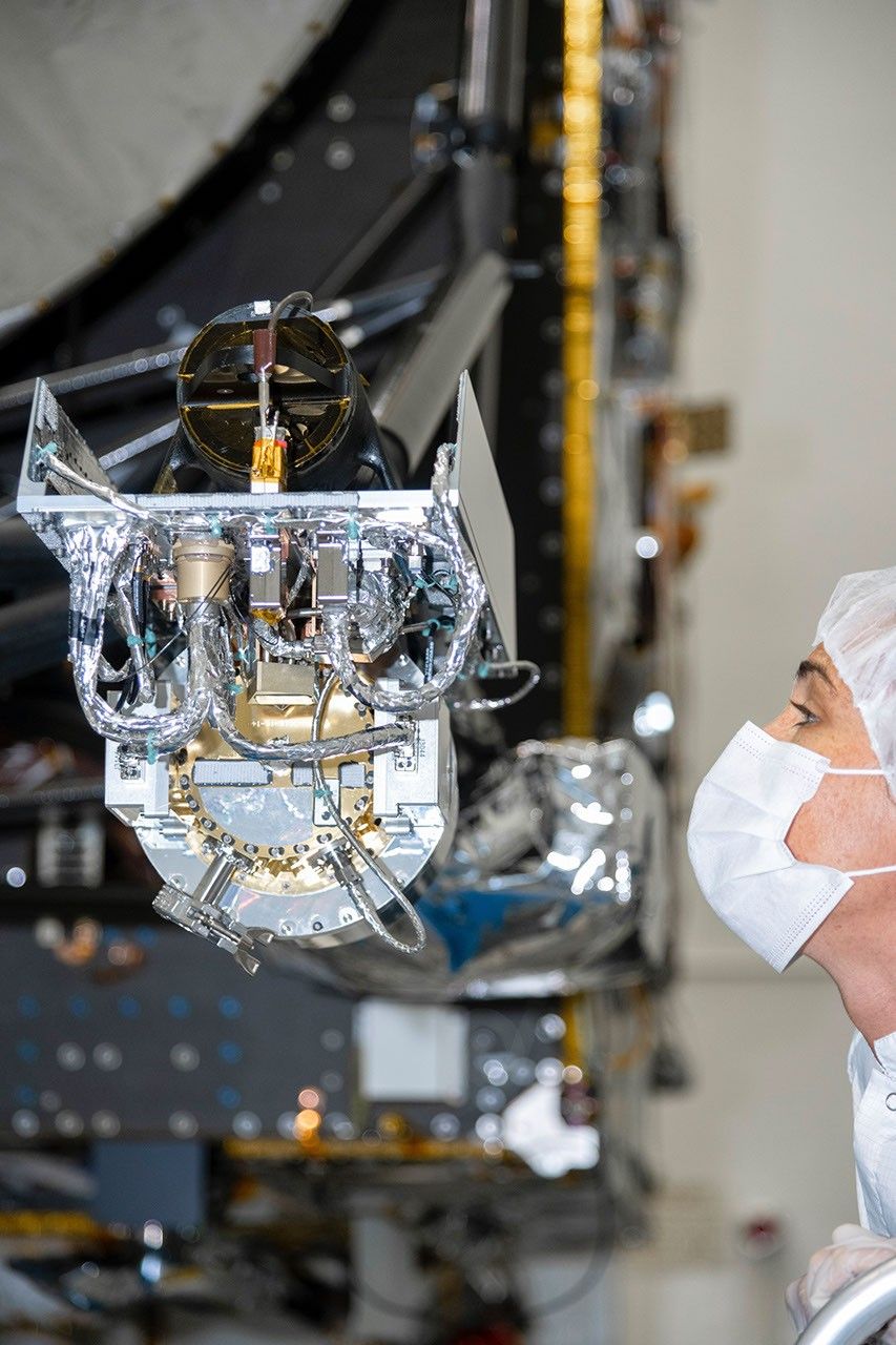 At NASA's Jet Propulsion Laboratory, an engineer inspects the gamma ray and neutron spectrometer as it is integrated into the agency's Psyche spacecraft. The instrument will help determine the elements that make up its target.