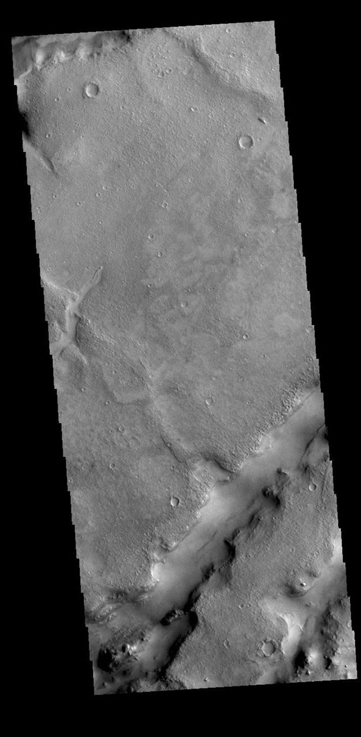 This image from NASA's Mars Odyssey shows linear depressions, part of Nili Fossae. Nili Fossae is a collection of curved faults and down-dropped blocks of crust between the faults called graben.