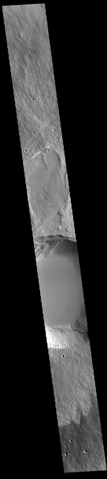 This image from NASA's Mars Odyssey shows a cross section of Pavonis Mons, including the central part of the smaller summit caldera (circular depression).