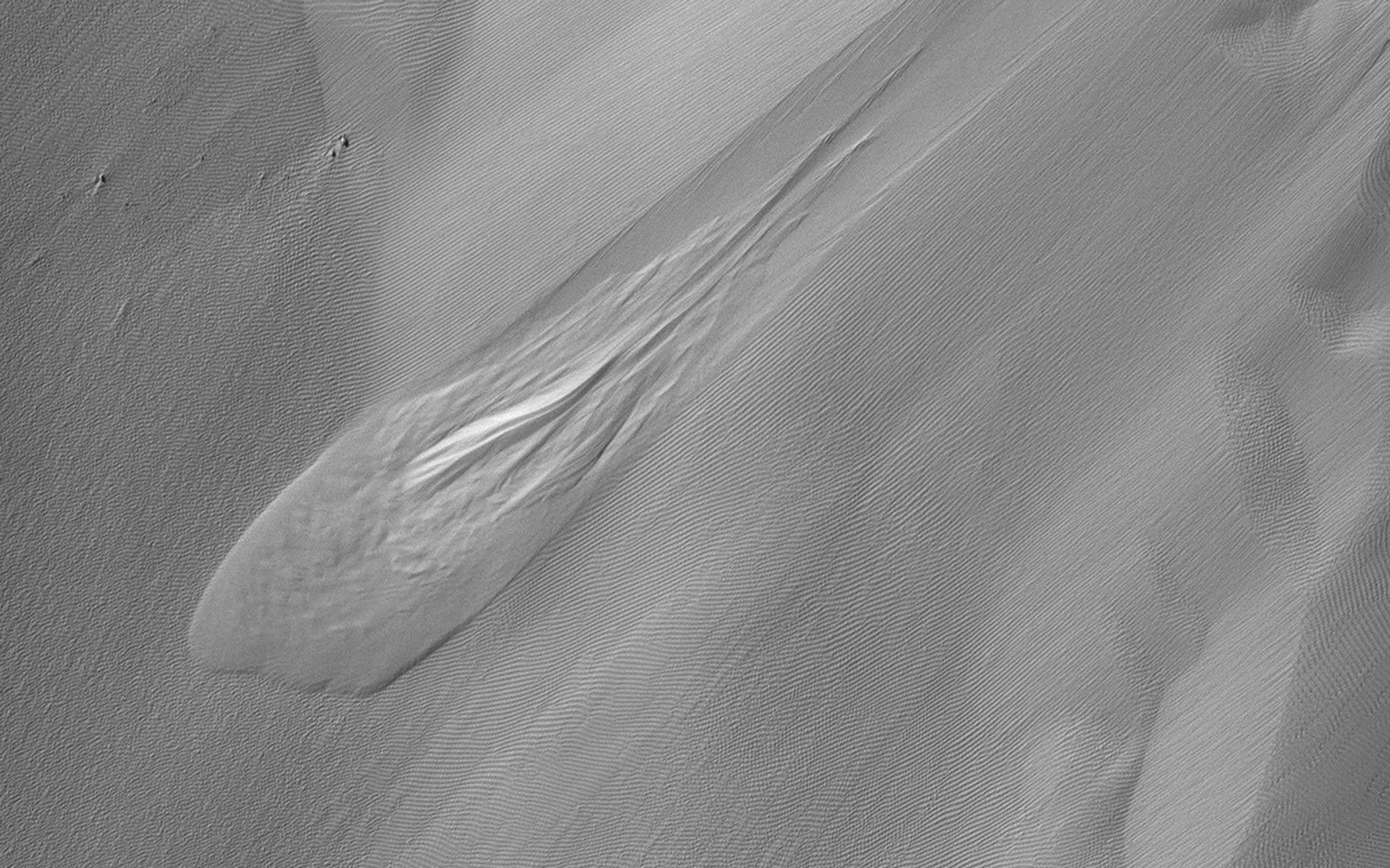This image acquired on November 26, 2021 by NASA's Mars Reconnaissance Orbiter, shows a slump, a mass of loosely consolidated material or a rock layer that moves a short distance down a slope.