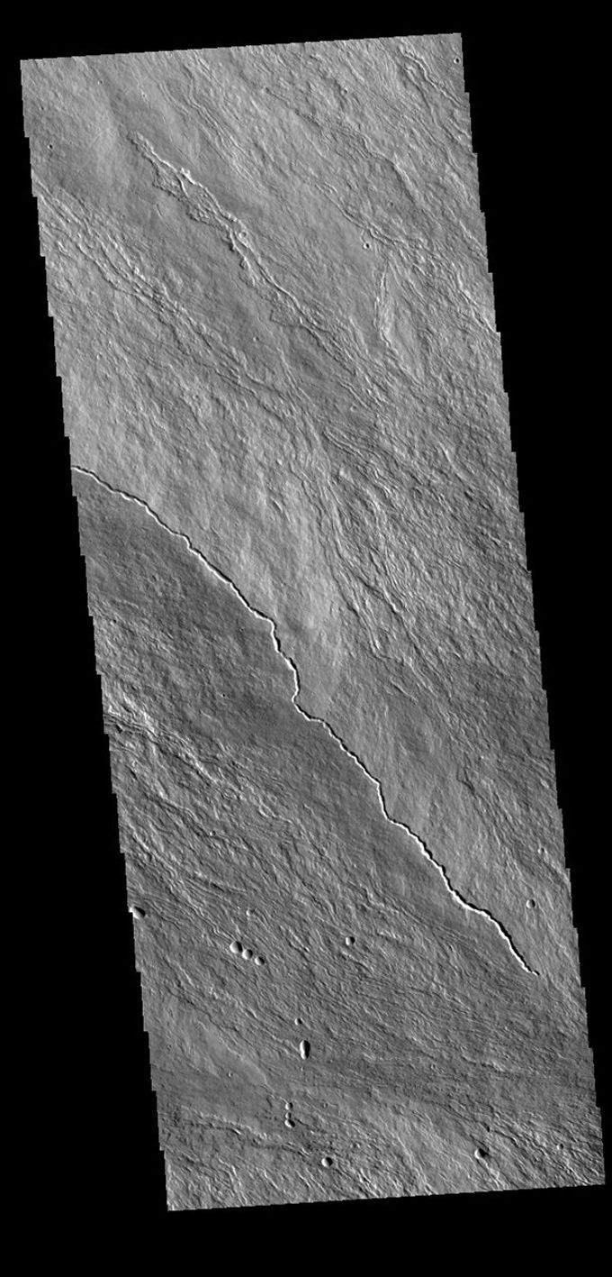 This image from NASA's Mars Odyssey shows the upper slopes of Olympus Mons. Numerous thin lava flows are visible.