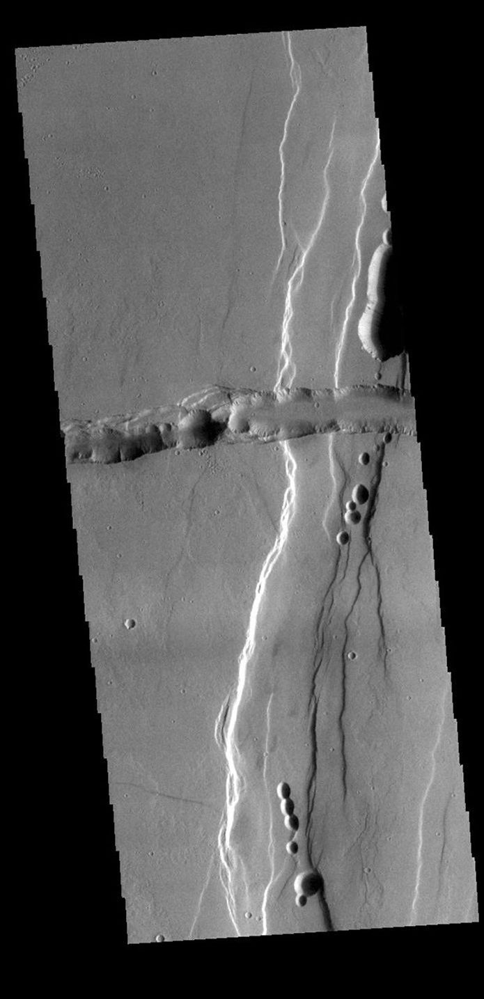 This image from NASA's Mars Odyssey shows part of Tractus Catena, just one of many north/south trending tectonic graben located south and east of Alba Mons.