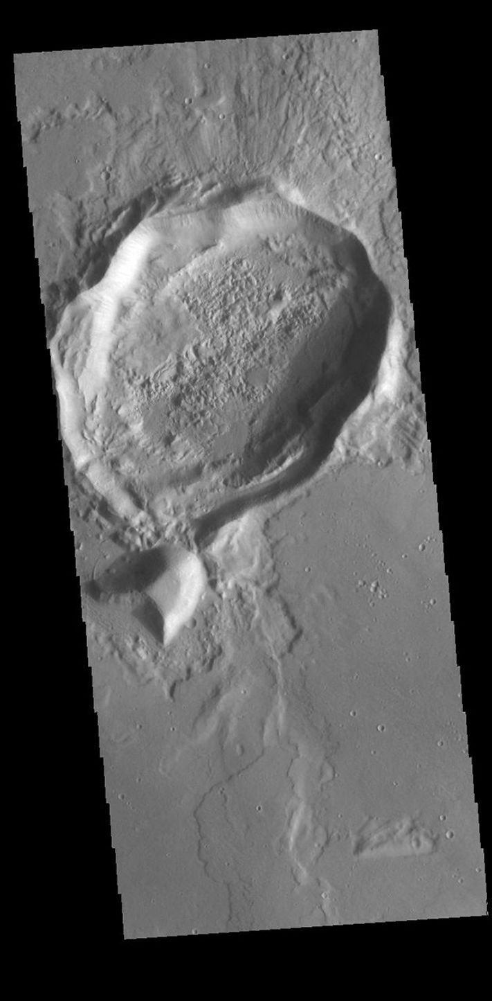 This image from NASA's Mars Odyssey shows a crater, crated by an impact event, that resulted in a form that is not the normal circular shape.