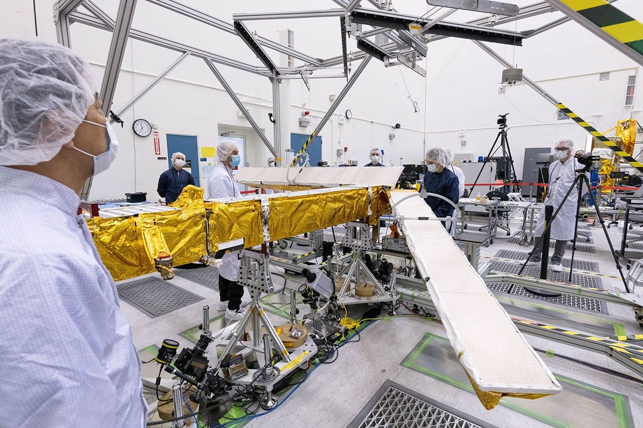 Members of the international SWOT mission test one of the antennas for the Ka-band Radar Interferometer (KaRIn) instrument in a clean room at NASA's Jet Propulsion Laboratory in Southern California.