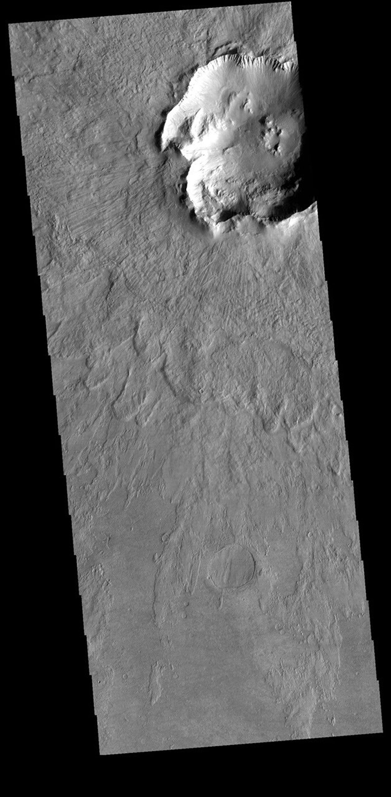 This image from NASA's Mars Odyssey shows part of a crater and its ejecta. Located in Noachis Terra, this impact crater is not the typical round shape.