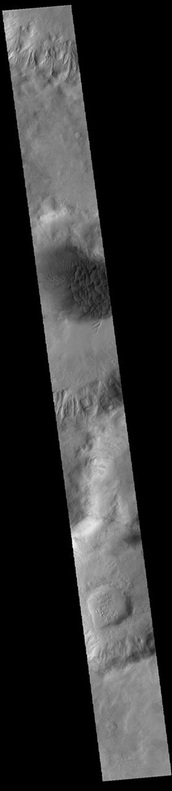 This image from NASA's Mars Odyssey shows a large sand sheet with surface dune forms as well as smaller sand dunes within an unnamed crater in Noachis Terra.