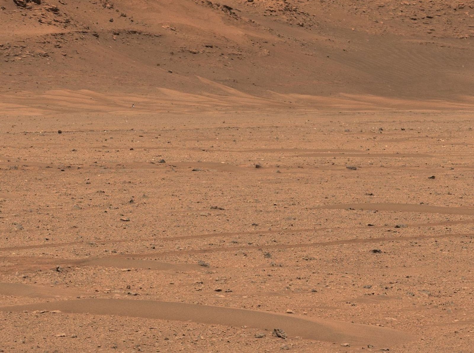 NASA's Perseverance Mars rover captured the agency's Ingenuity Mars Helicopter in the distance, near the base of Jezero Crater's river delta, in this image taken Dec. 18, 2022.