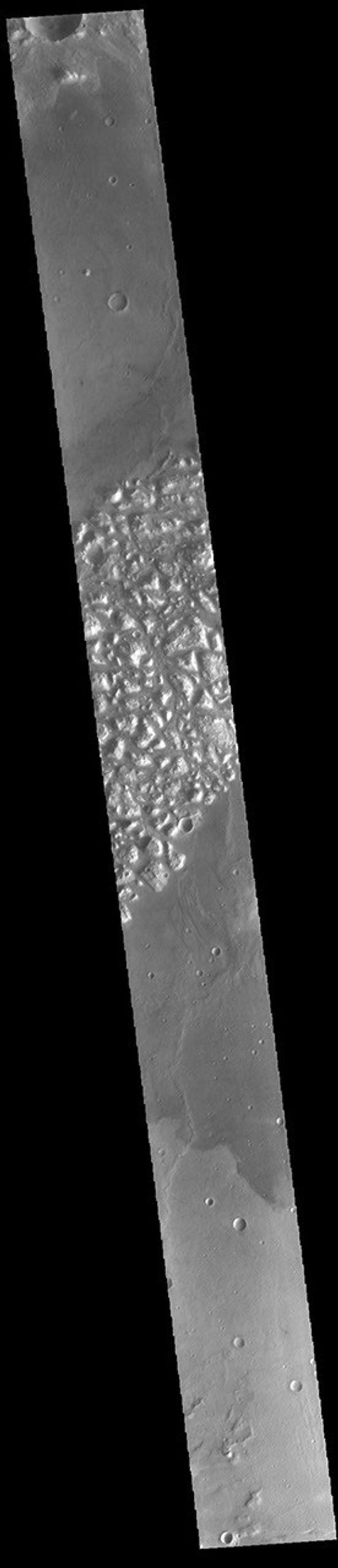 This image from NASA's Mars Odyssey shows part of Atlantis Chaos. Chaos terrain is typified by regions of blocky, often steep sided, mesas interspersed with deep valleys.