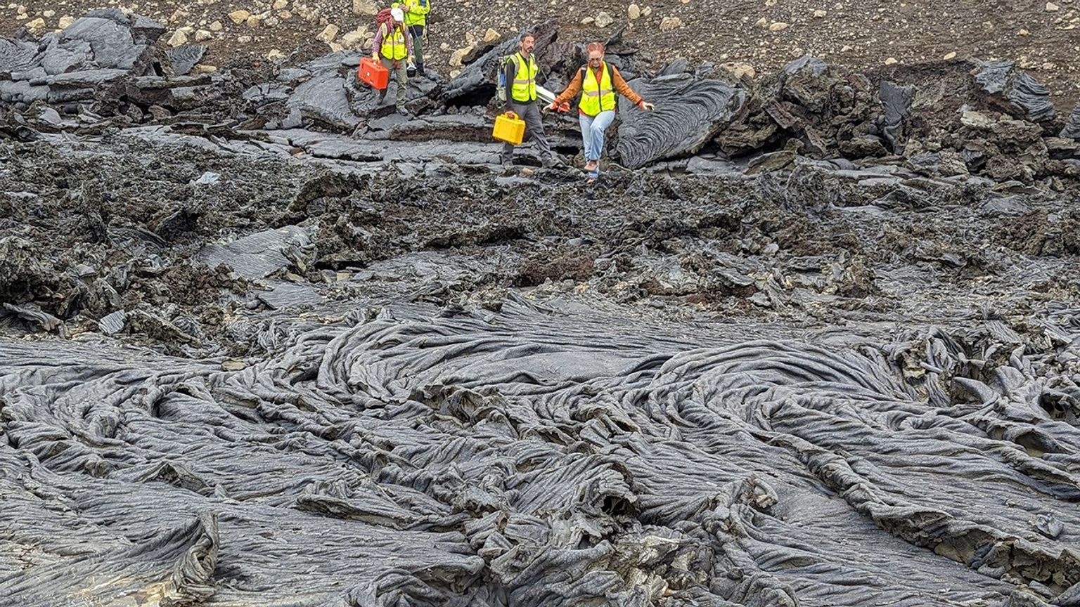 Members of the VERITAS science team descend a slope to new rock formed from a recent flow of lava during their Iceland field campaign in early August, 2023. The team used the volcanic landscape as a Venus analog to test radar technologies and techniques.