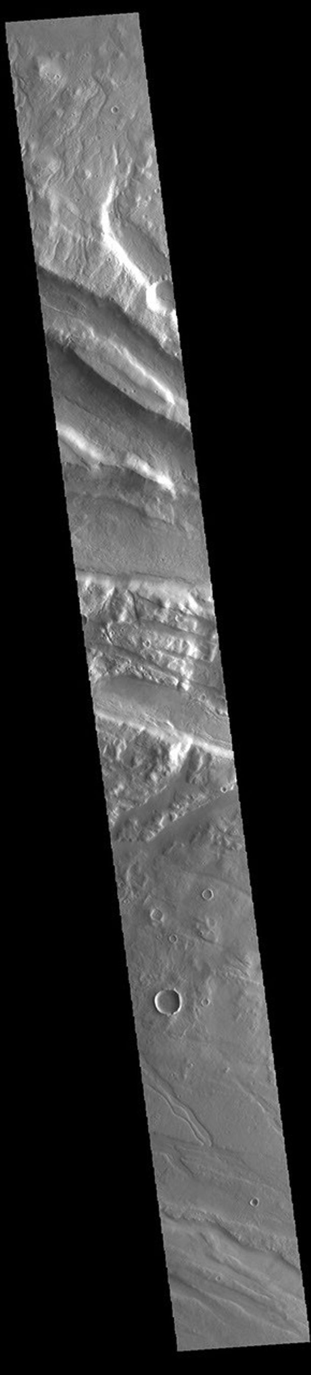 This image from NASA's Mars Odyssey shows part of Acheron Fossae. Acheron Fossae is the highly fractured, faulted and deformed terrain located north of the large shield volcano Olympus Mons.