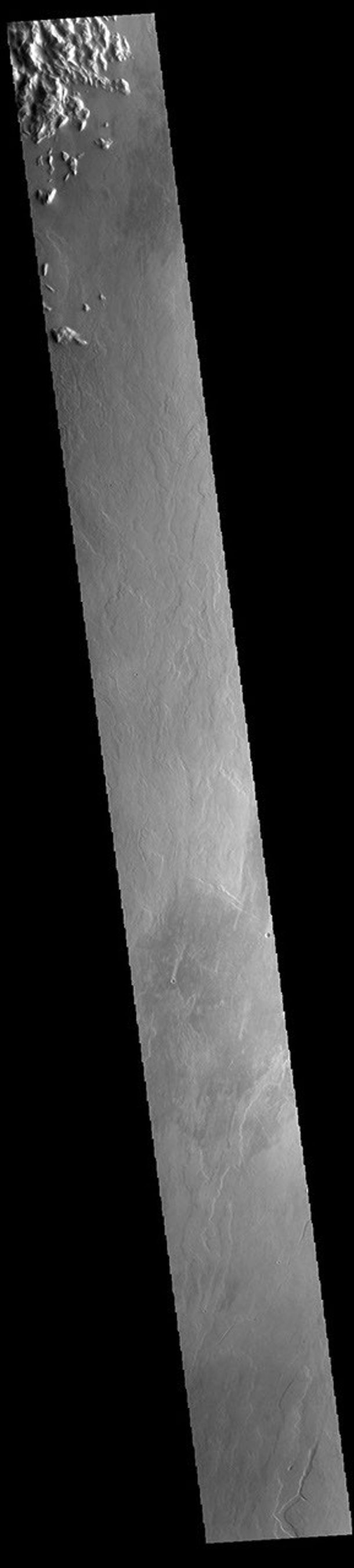 This image from NASA's Mars Odyssey shows an area east of Olympus Mons. The majority of the image is comprised of volcanic flows.