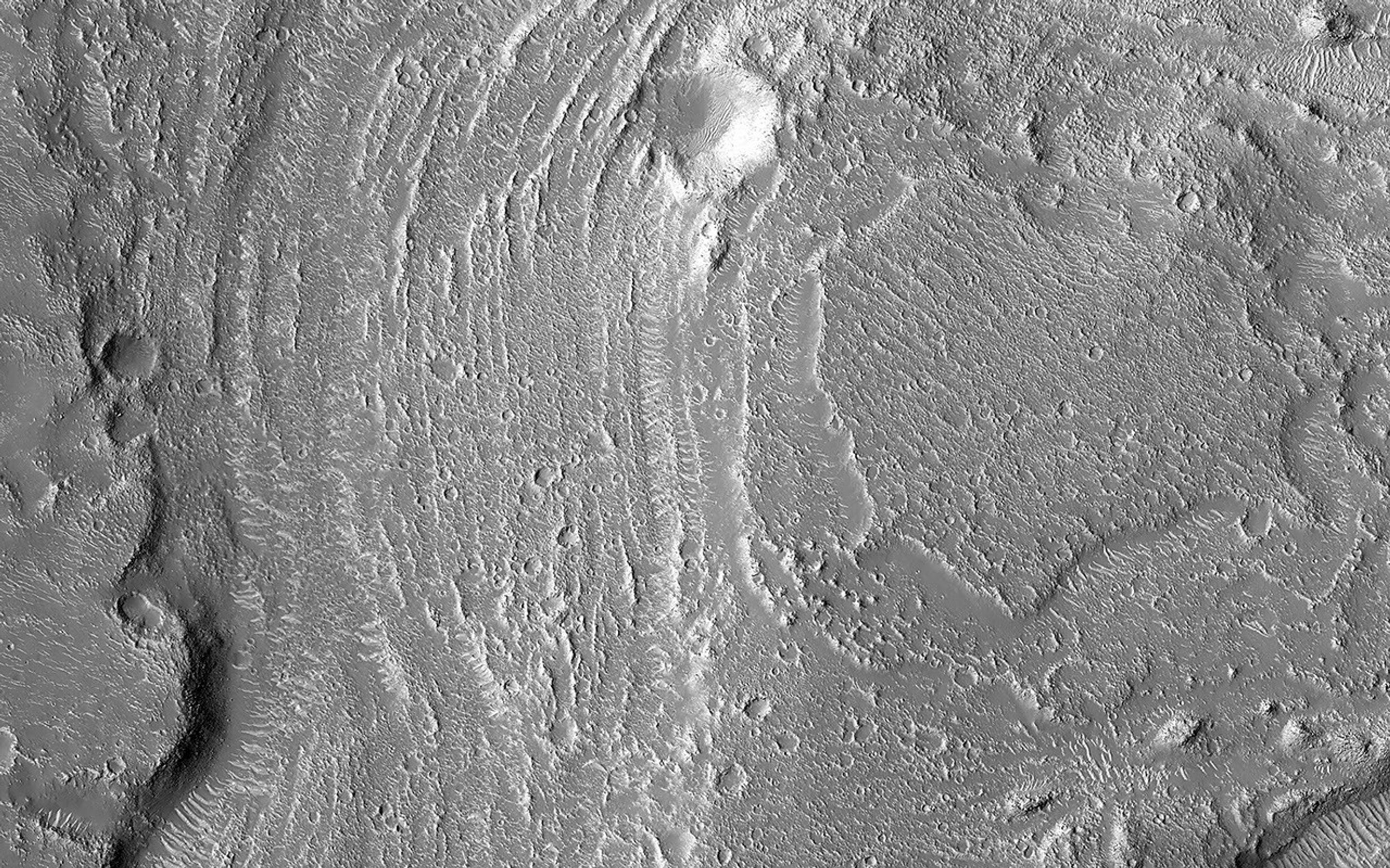 This image acquired on September 14, 2023 by NASA's Mars Reconnaissance Orbiter shows large, streamlined features and grooves that have been carved by enormous water volumes into the floor of Granicus.
