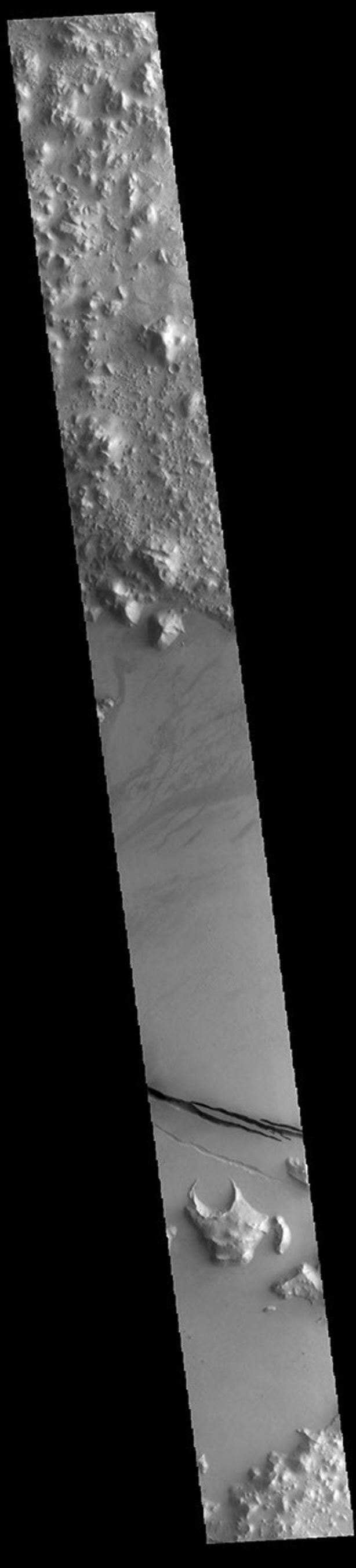 This image from NASA's Mars Odyssey shows a section of Cerberus Fossae. Cerberus Fossae are located in Elysium Planitia, southeast of the Elysium Mons volcanic complex.