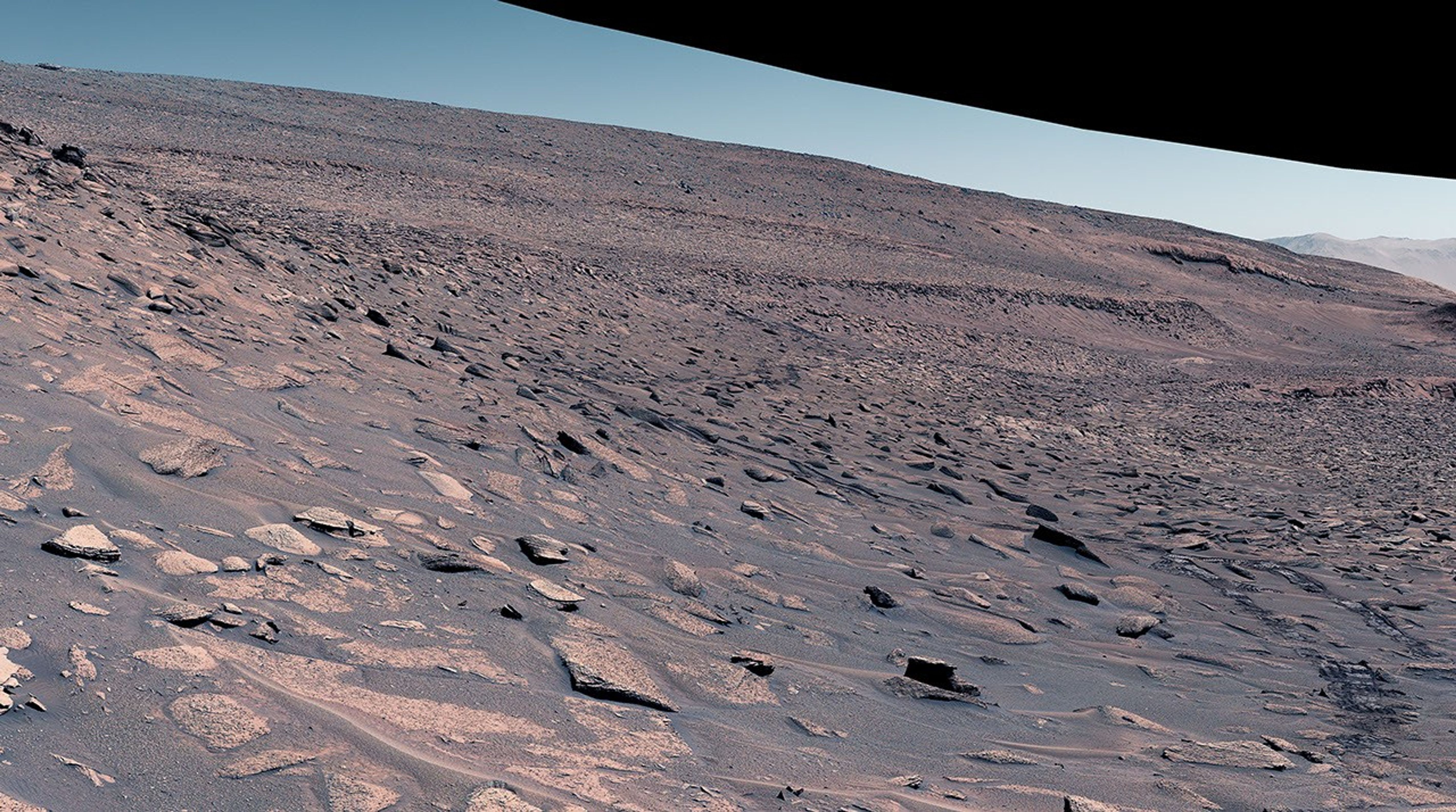 NASA's Curiosity Mars rover attempted to climb a slope near the center of this image, but struggled due to the incline, slippery sand, and wheel-size rocks.