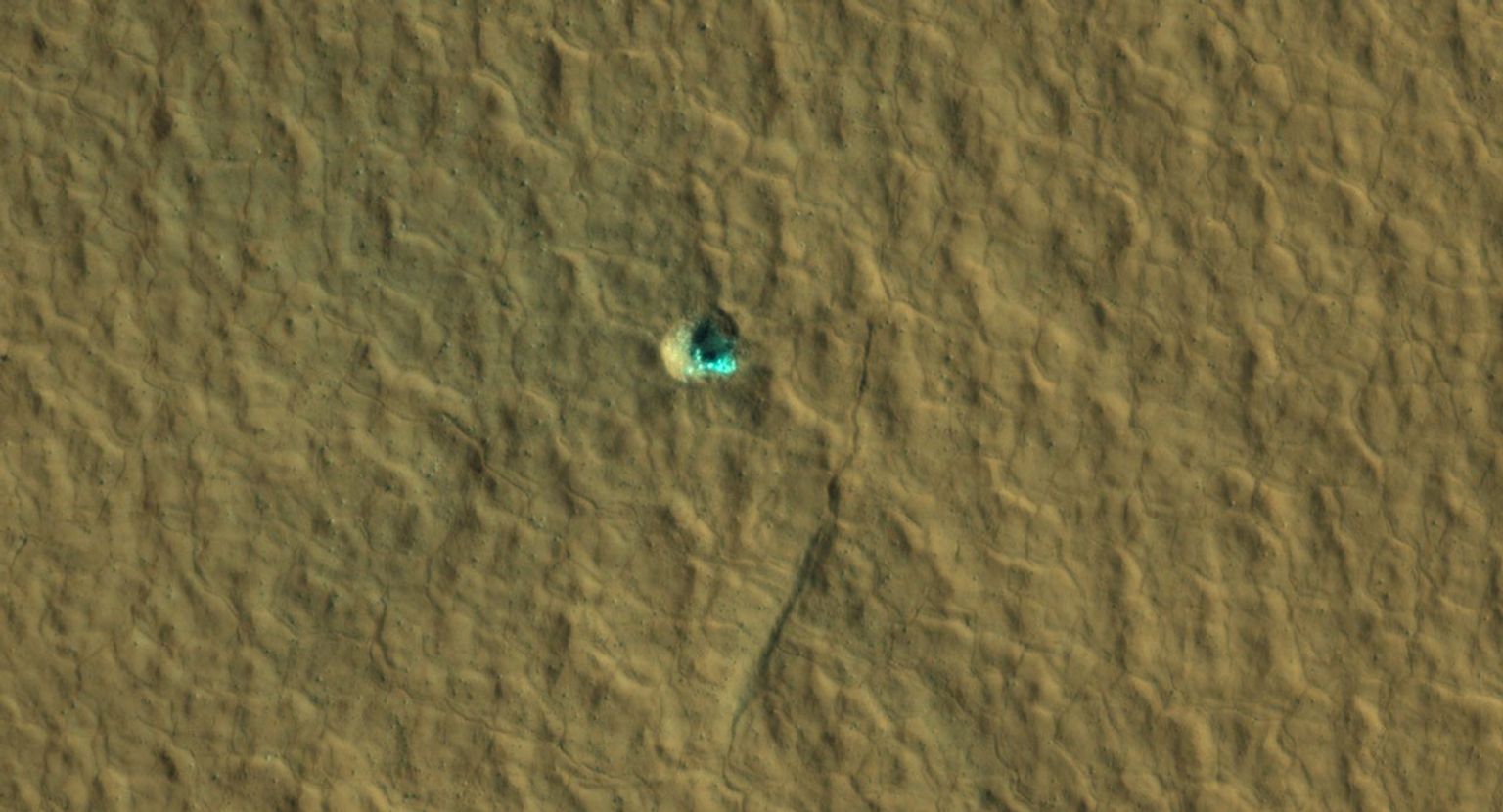 The ice-exposing impact crater at the center of this image is an example of what scientists look for when mapping places where future astronauts should land on Mars.