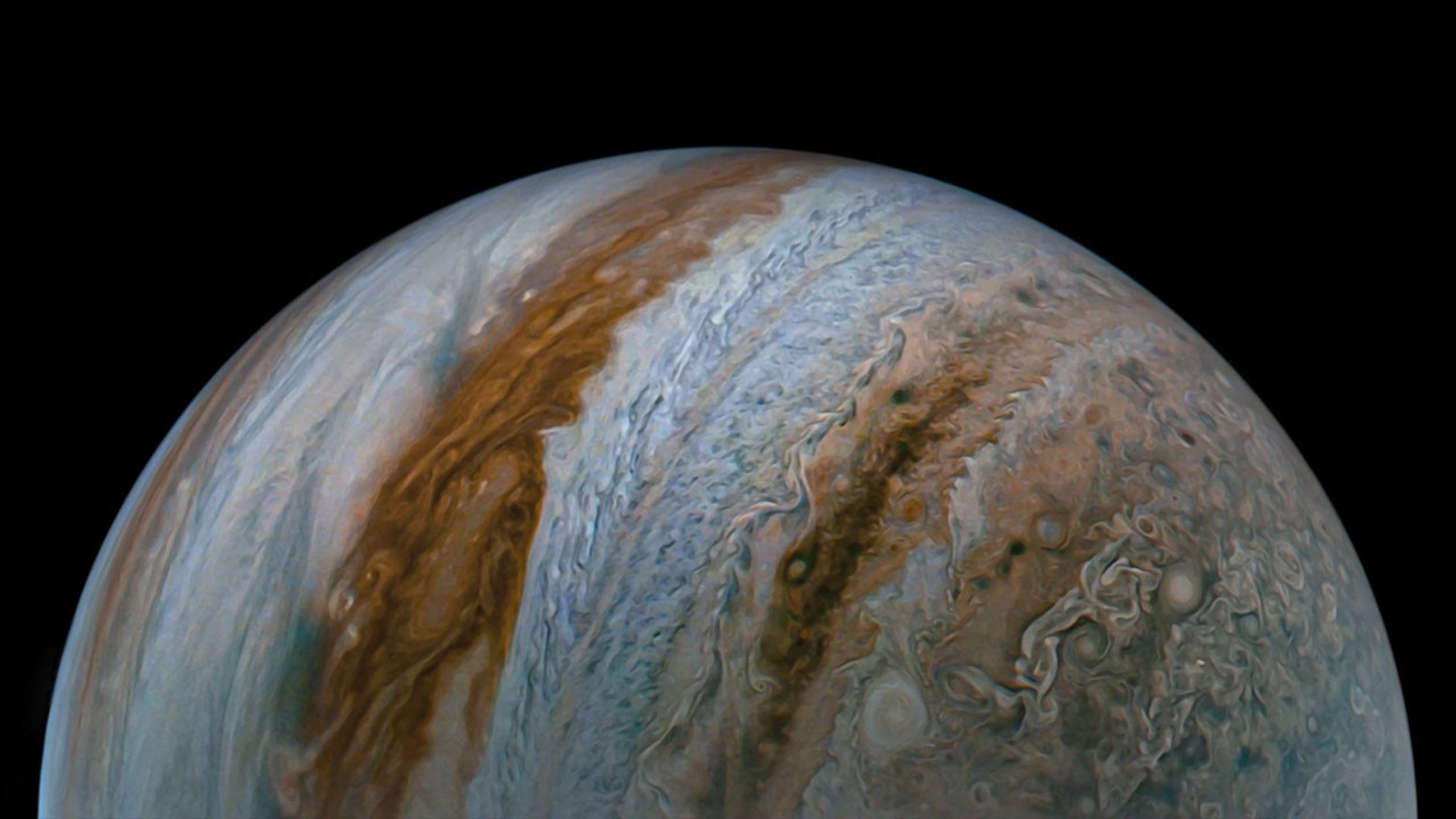 NASA's Juno captured this view of Jupiter during the mission's 54th close flyby of the giant planet on Sept. 7, 2023. The image was made with raw data from the JunoCam instrument that was processed to enhance details in cloud features and colors.
