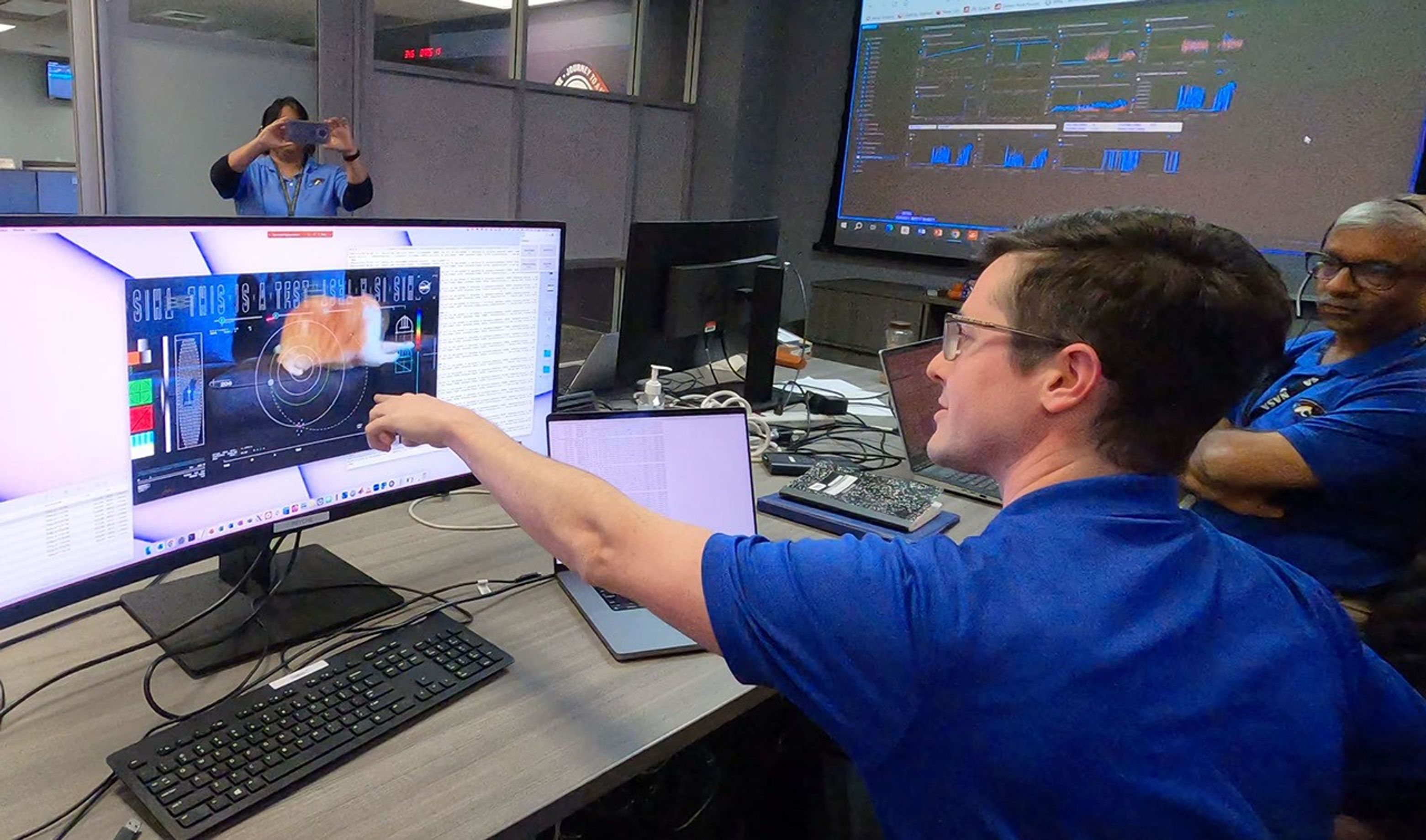 Members of the DSOC team react to the first high-definition streaming video to be sent via laser from deep space on Dec. 11, 2023, at NASA's Jet Propulsion Laboratory.