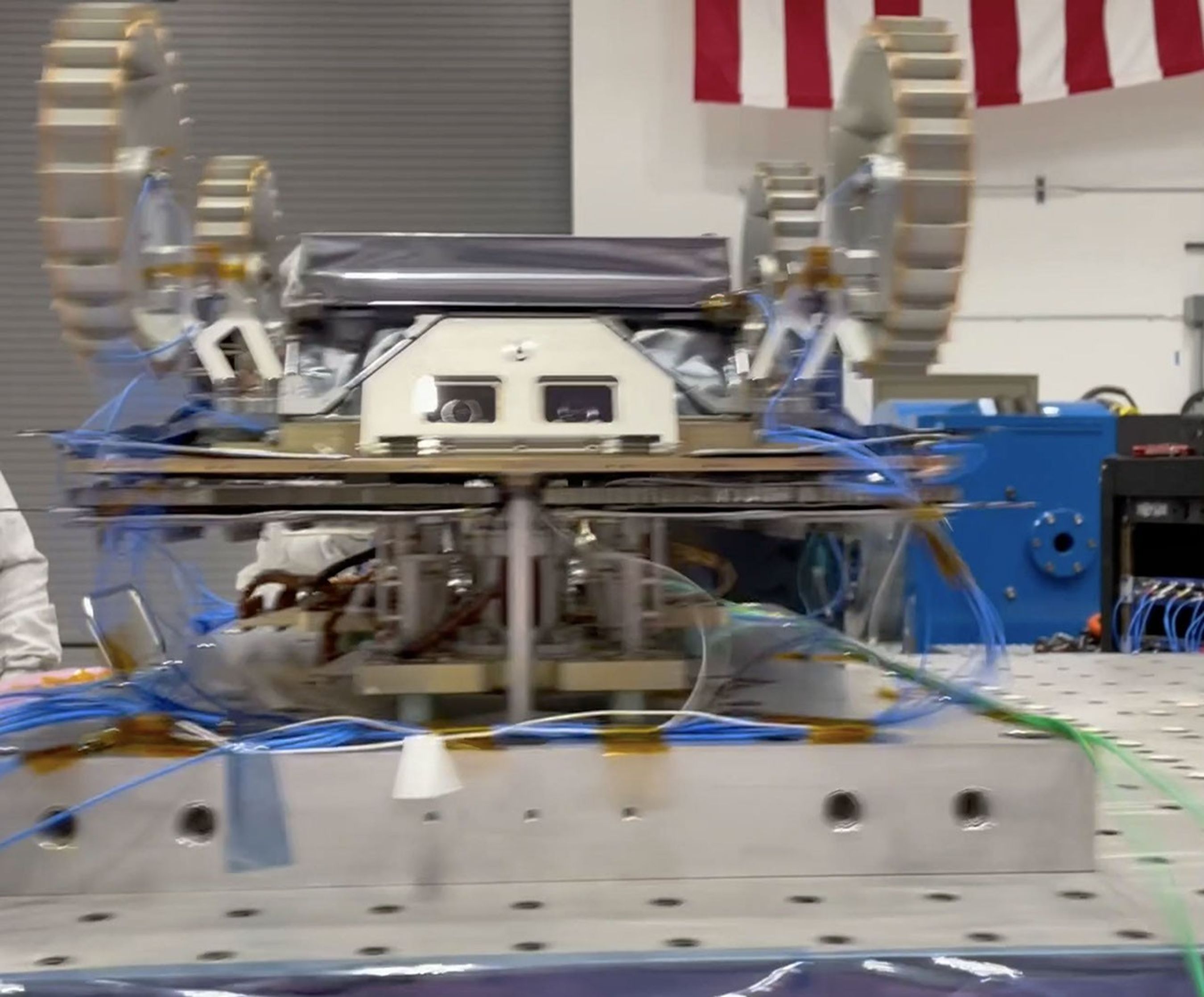 Clamped to a shaker table, one of NASA's CADRE rovers gets shaken vigorously during a test in November 2023.