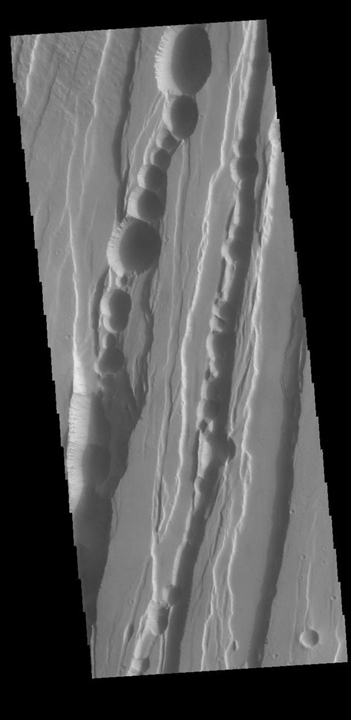 This image from NASA's Mars Odyssey shows part of Tractus Catena, just one of many north/south trending tectonic graben located south and east of Alba Mons.