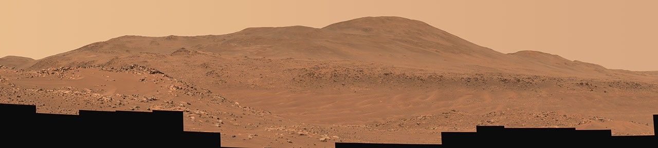 This natural-color mosaic showing NASA's Ingenuity Mars Helicopter at Valinor Hills was acquired by the agency's Perseverance Mars rover on Feb. 21, 2024. The helicopter sits just left of center, a speck-like figure amid a field of sand ripples.