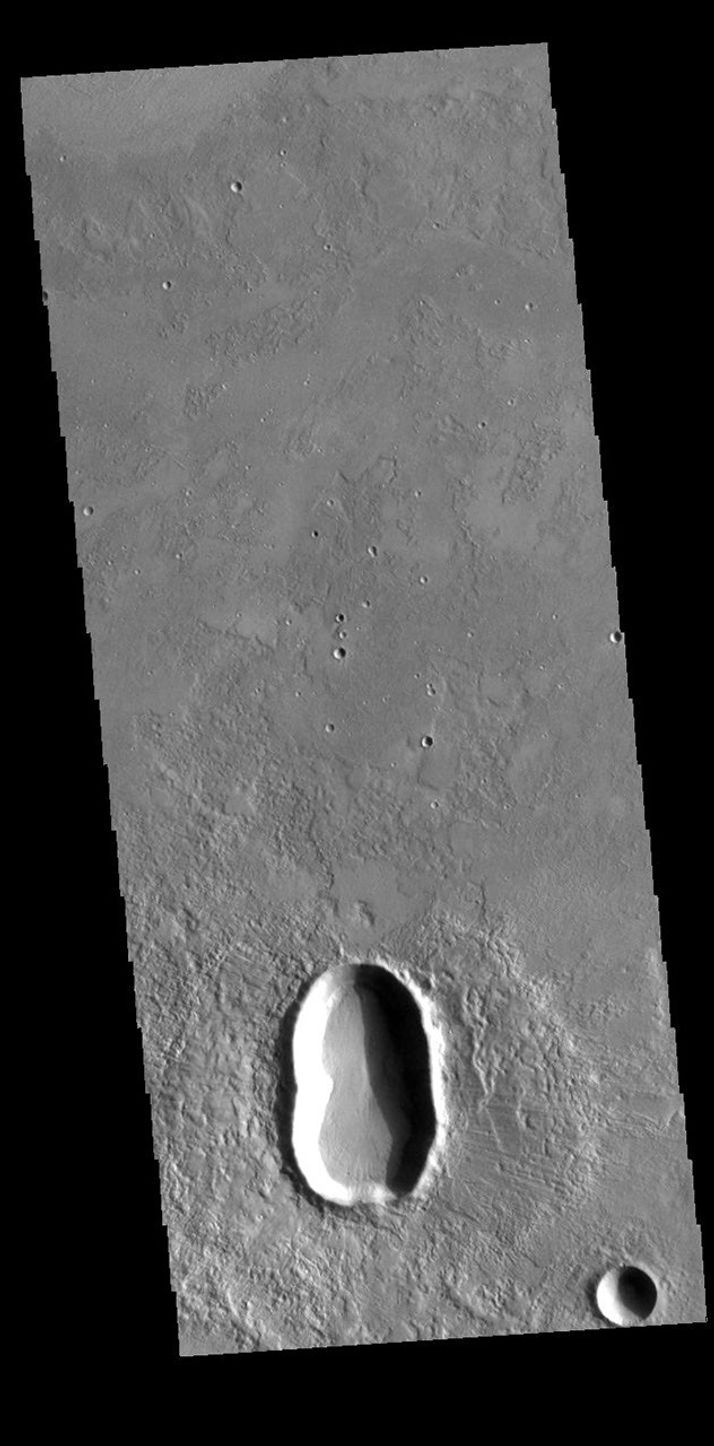 This image from NASA's Mars Odyssey shows an unnamed crater in Utopia Planitia, with an indentation in the crater rim at the middle of the crater.