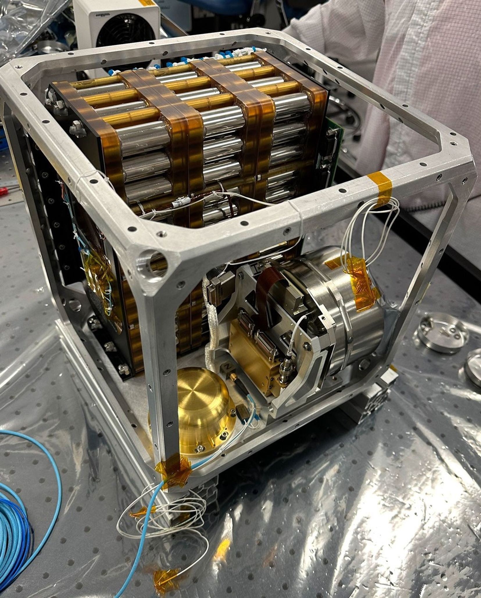 Seen here in November 2023, Farside Seismic Suite's inner cube houses the NASA payload's battery and two seismometers. The gold, puck-shaped device holds the Short Period sensor, while the silver enclosure contains the Very Broadband seismometer.