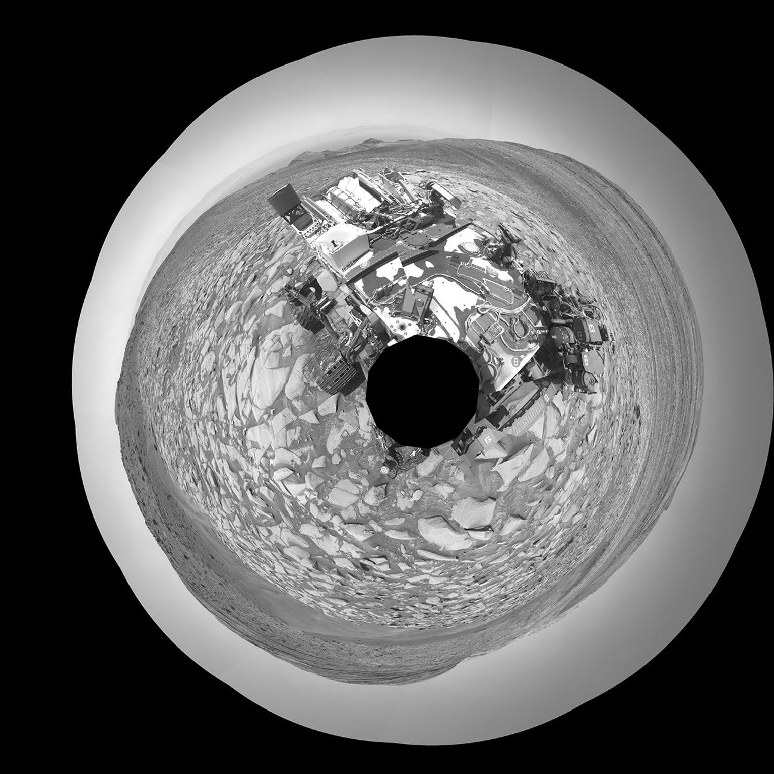 NASA's Curiosity Mars rover captured this selfie using its left black-and-white navigation camera on Feb. 3, 2024. The selfie is made up of 36 individual images that were stitched together after being sent back to Earth.