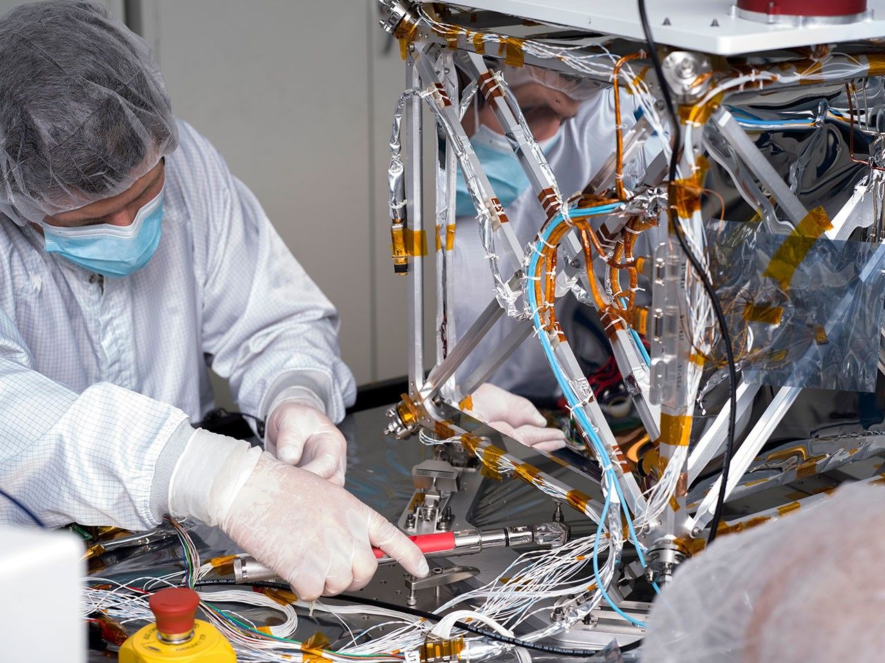 In a clean room at NASA's Jet Propulsion Laboratory in Southern California in March 2024, technician Nik Schwarz prepares the agency's Farside Seismic Suite (FSS) for testing.