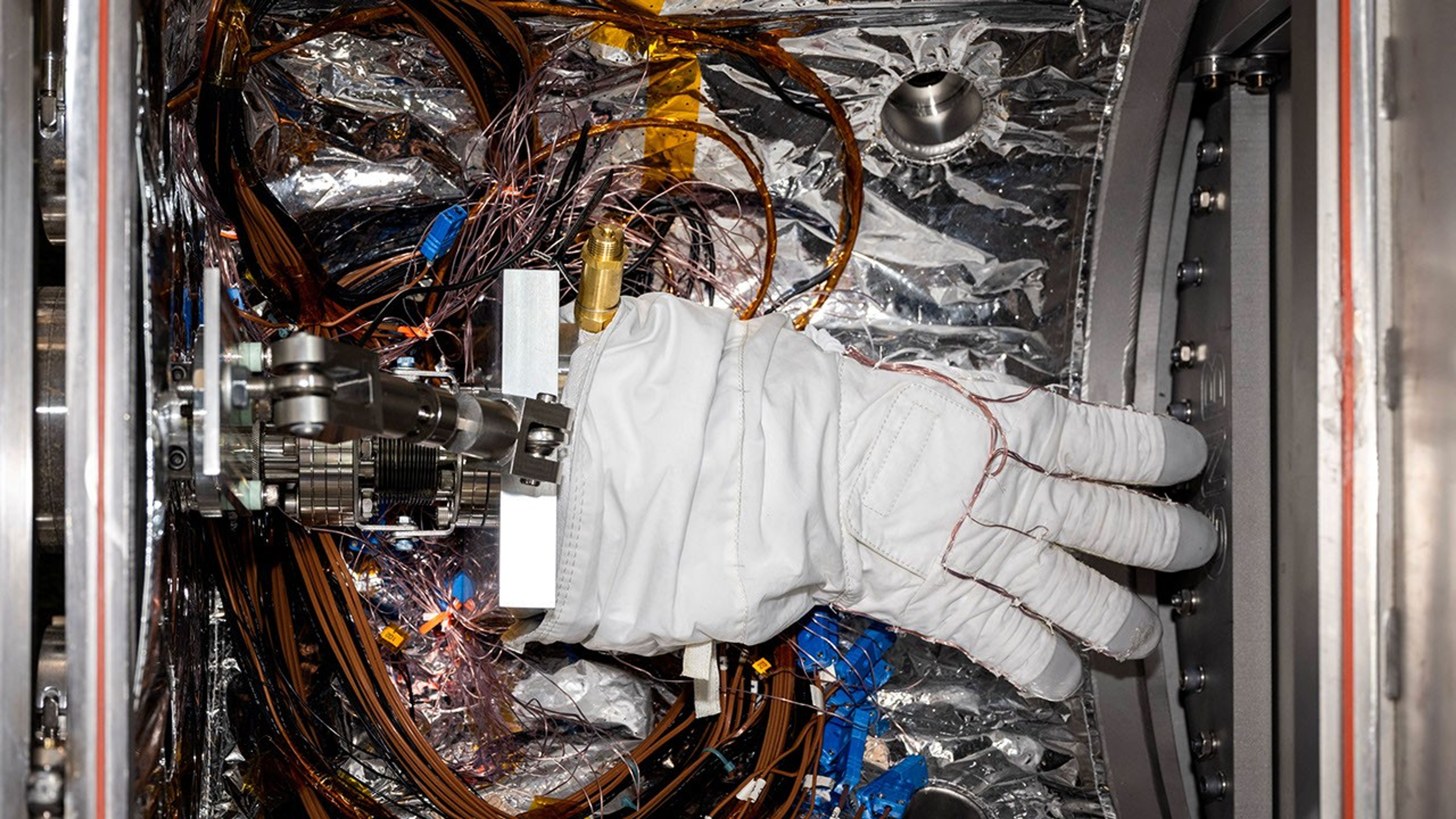 An astronaut glove is prepped for testing in a chamber called CITADEL at NASA JPL. Conducted at frigid temperatures, the testing supports next-generation spacesuit development.