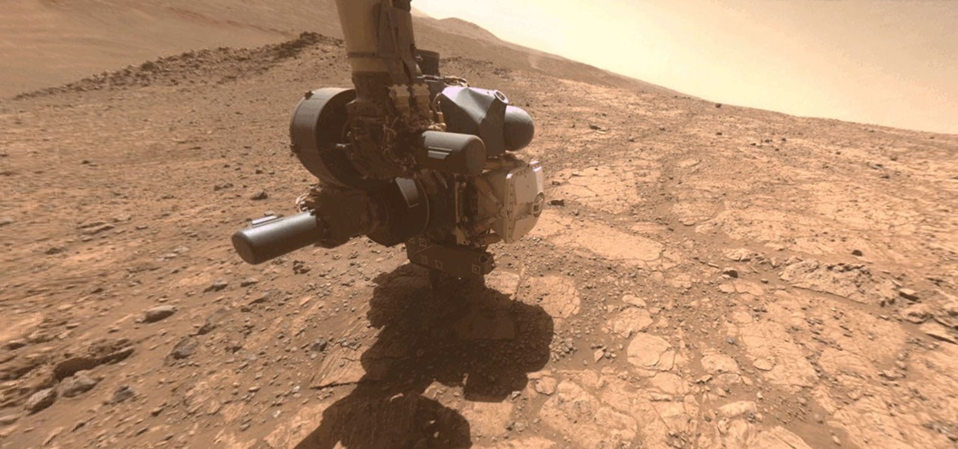 A dust devil whirled by in the distance as one of the cameras on NASA's Perseverance captured the Mars rover coring a sample near the rim of Jezero Crater on April 29, 2025.