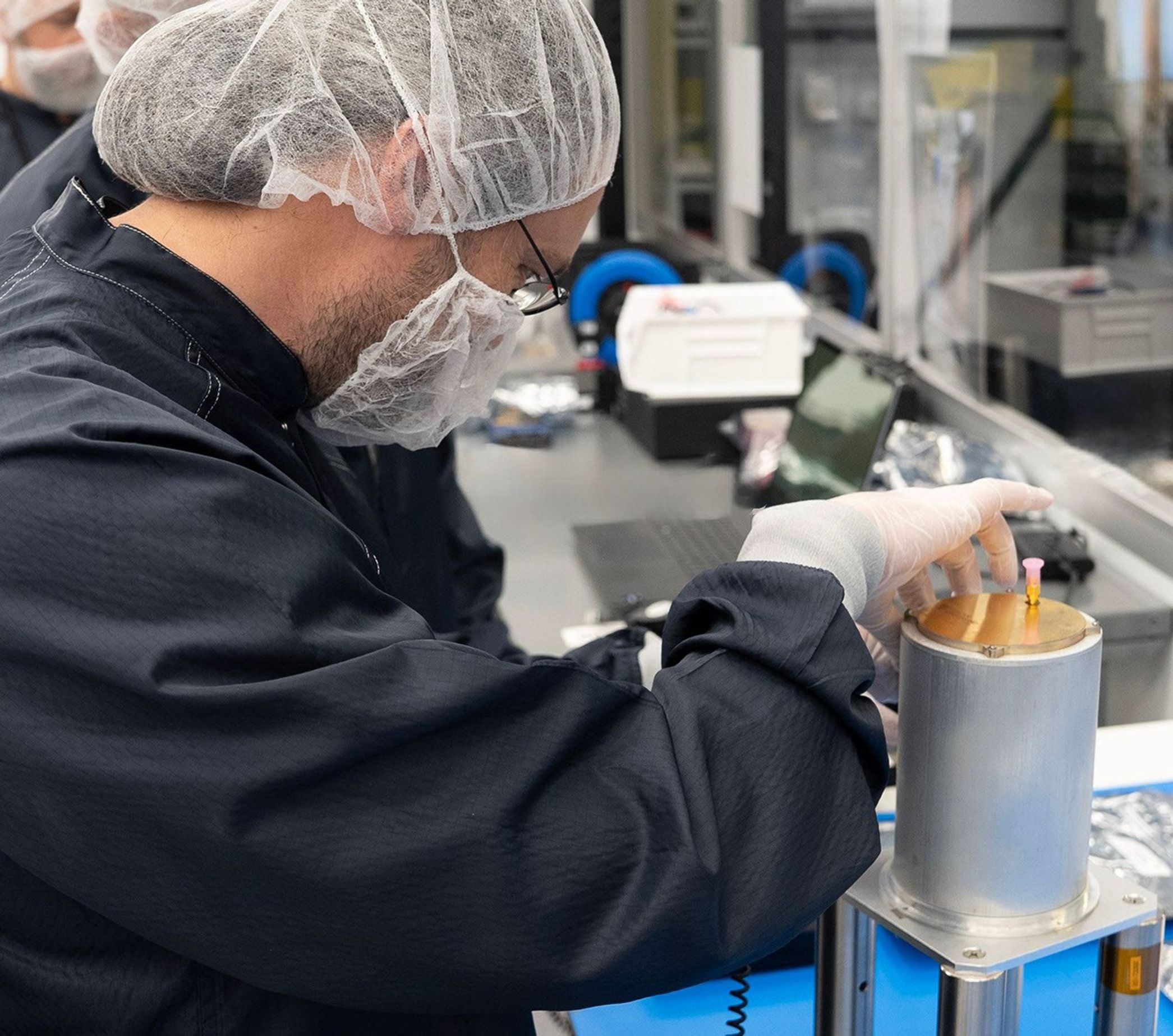 Engineer Emmanuel Decrossas of NASA's Jet Propulsion Laboratory makes an adjustment to part of a NASA telecommunications payload called User Terminal, at Firefly Aerospace's facility in Cedar Park, Texas, in August 2025.