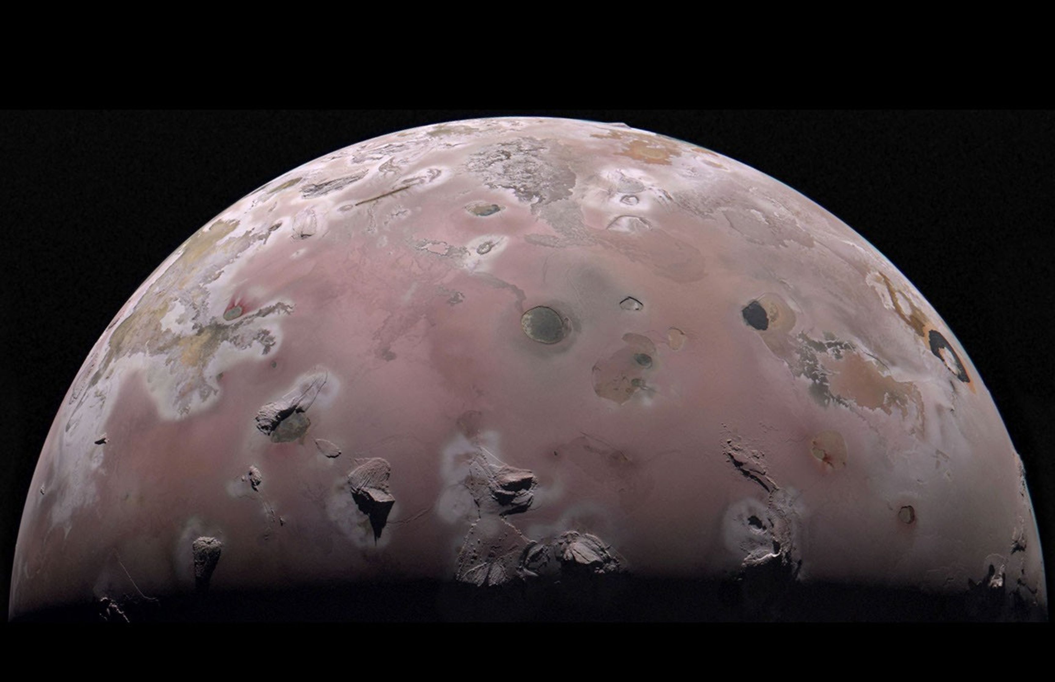 A reddish moon with lumps and splotches indicating volcanic activity.