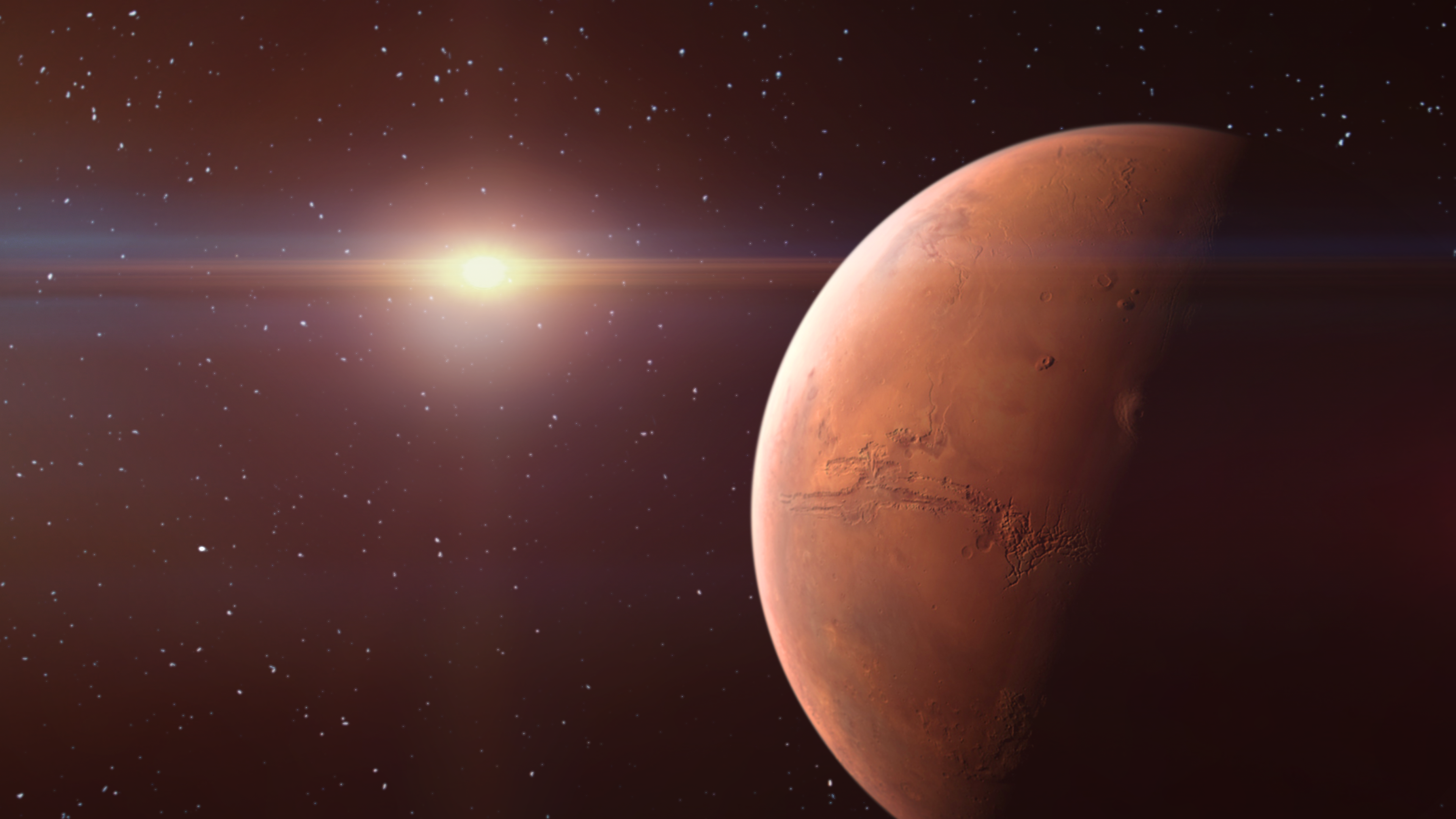 The limb of Mars in space is illuminated by the Sun.