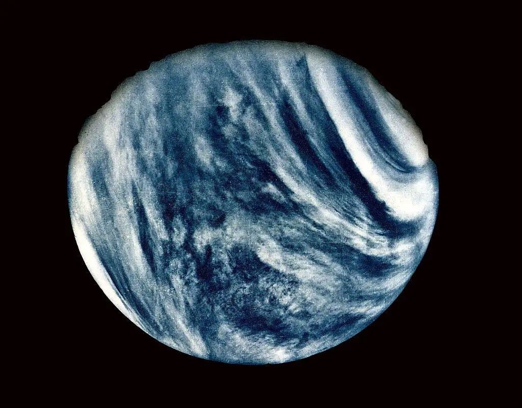 The image has been enhance to show the clouds shrouding Venus, so the planet looks a bit like Earth, or a blue marble, in this image.