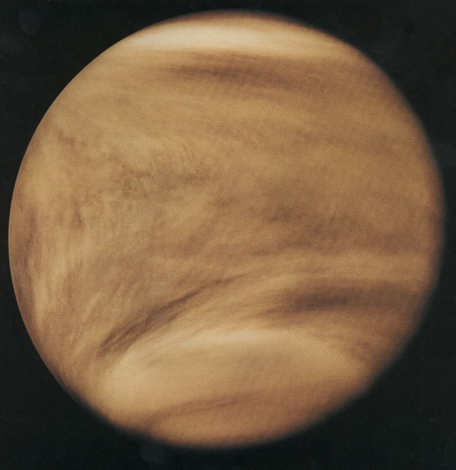 Venus appears like a globe of gold and brown swirls.