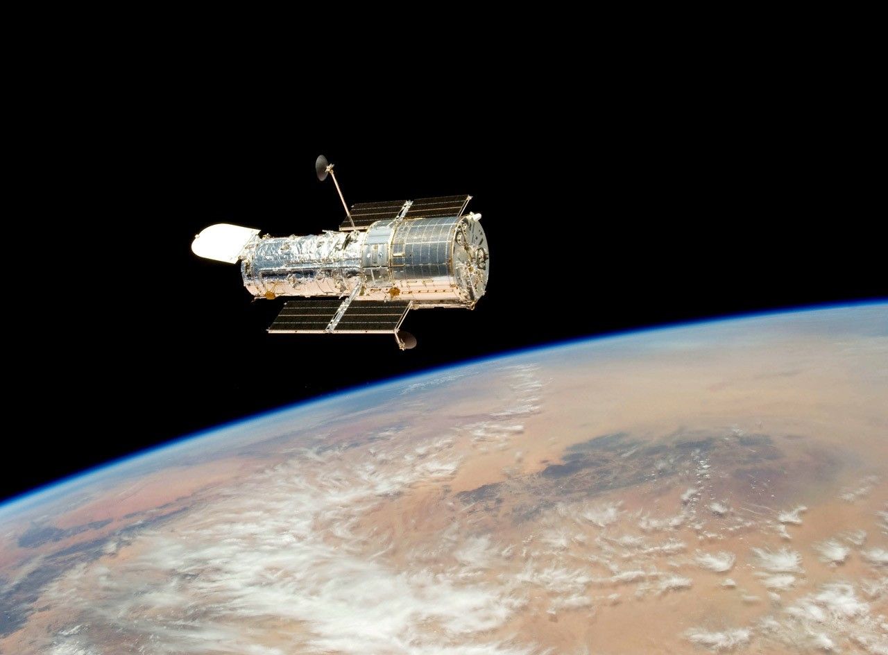 Hubble orbiting above Earth.