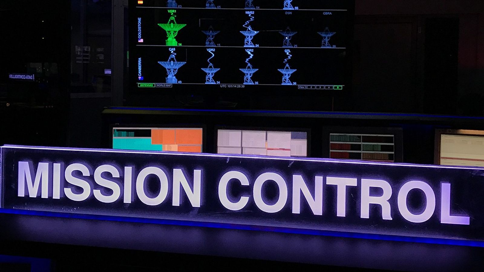 Color image of mission control showing computer screens.