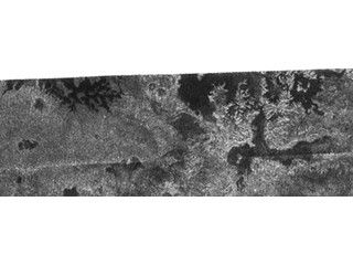 Lakes and More Lakes: In this image taken by the Cassini radar system on Oct. 9, 2006, a previously unseen style of lakes is revealed. The lakes here assume complex shapes and are among the darkest seen so far on Titan.