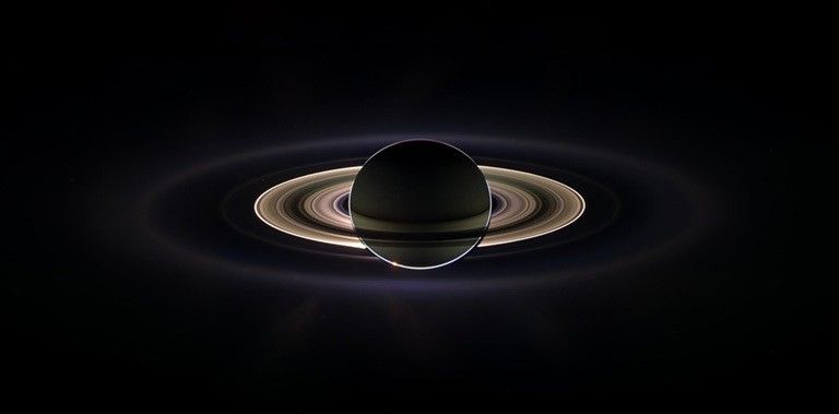 With giant Saturn hanging in the blackness and sheltering Cassini from the sun's blinding glare, the spacecraft viewed the rings as never before, on Sept. 15, 2006.