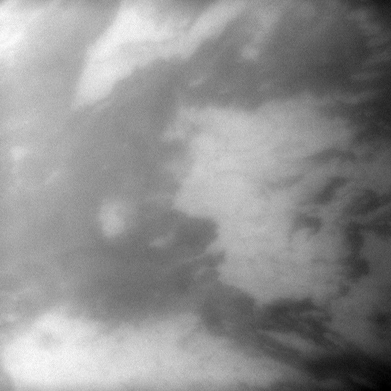 The Cassini spacecraft takes a look through the atmosphere of Saturn's largest moon to spy light and dark in the area called Adiri on Titan. The image was taken Jan. 29, 2010.