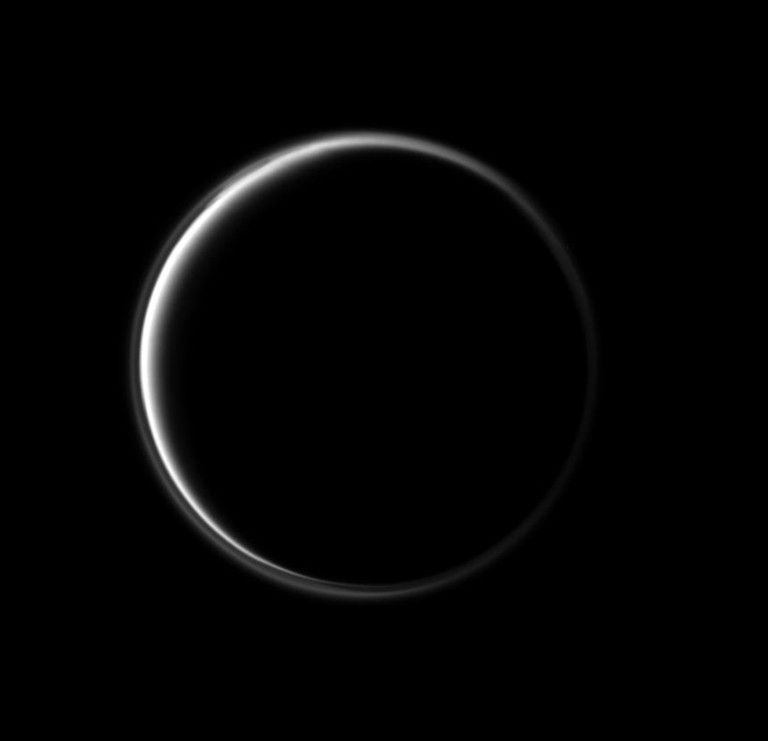 The Cassini spacecraft looks at the dark side of Saturn's largest moon. The narrowing circle of light surrounding Titan is produced by sunlight scattering through Titan's atmosphere.