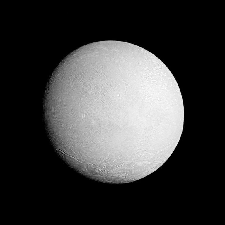 The Cassini spacecraft looks at a brightly illuminated Enceladus and examines the surface of the leading hemisphere of this Saturnian moon.