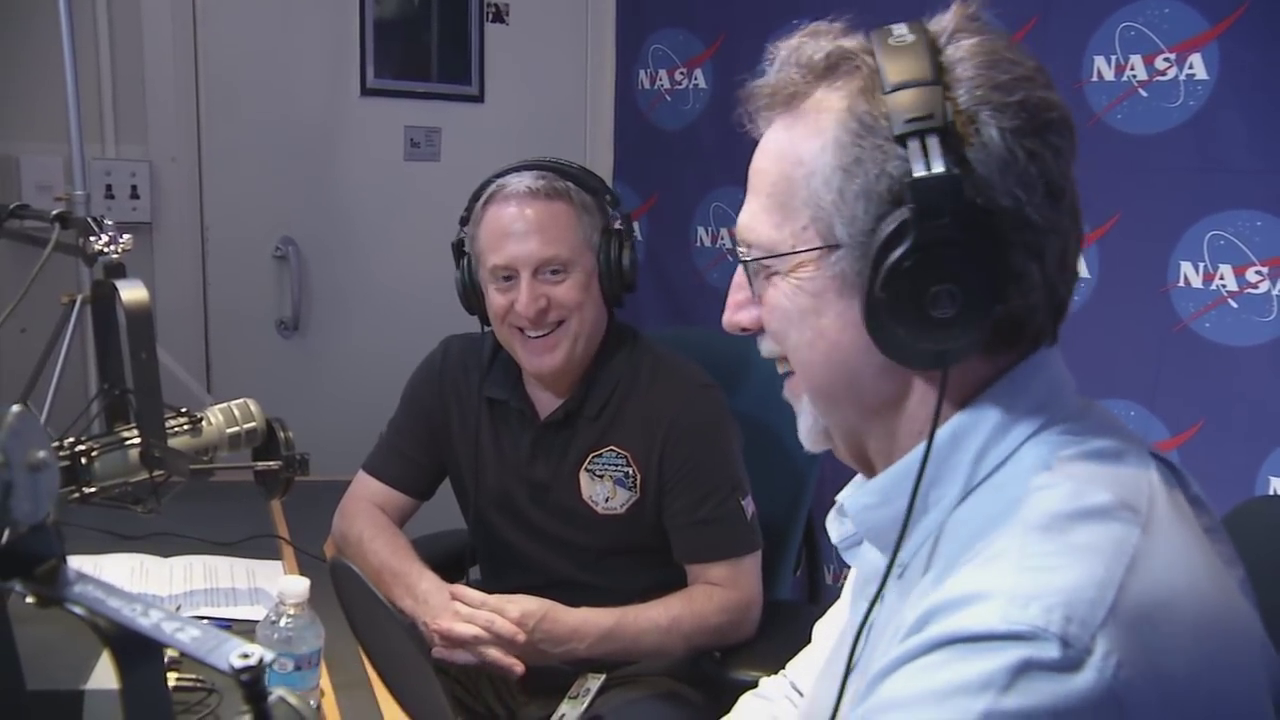 guests speaking in studio with mics