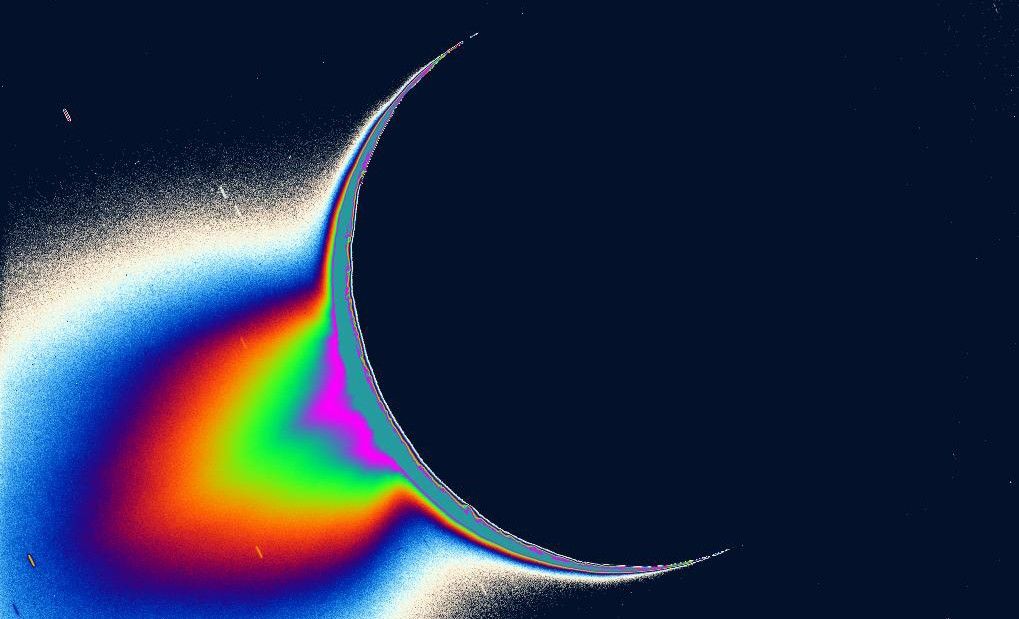 The greatly enhanced and colorized image of Enceladus and its plume backlit by the Sun.