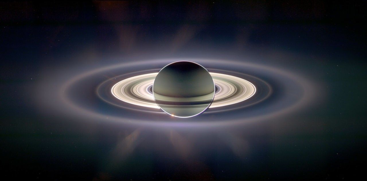 With giant Saturn hanging in the blackness and sheltering Cassini from the sun's blinding glare, the spacecraft viewed the rings as never before, revealing previously unknown faint rings and even glimpsing its home world. > Full image and caption