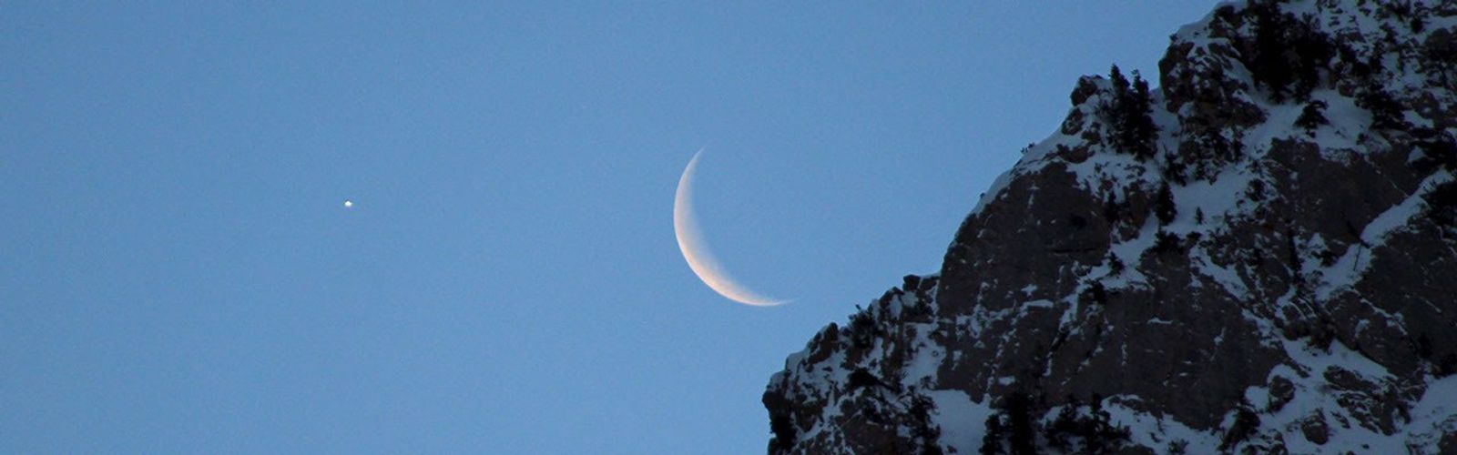 Bright Venus, a crescent Moon and the edge of a mountain in Utah.