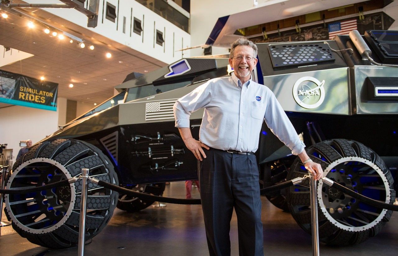 Jim Green with a futuristic prototype space car.