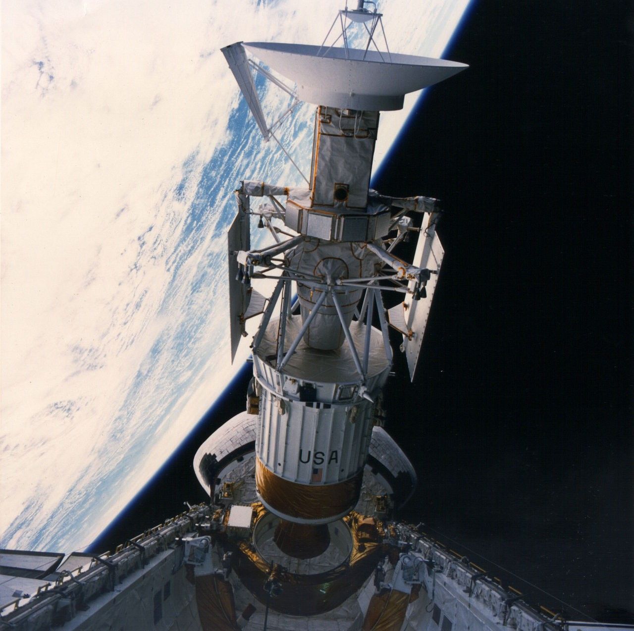 Magellan and Space Shuttle above Earth.